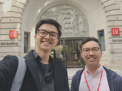 Dr. Haziq (right) and Ahmad Zakwan (left) in front of the iconic Old Building at the heart of LSE